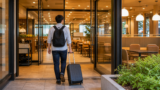 traveler entering a bright Japanese family restaurant with one carry-on suitcase