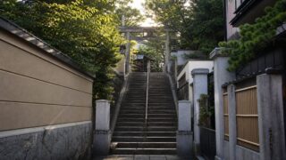Quiet Tokyo shrine staircase at morning light for a Your Name pilgrimage route