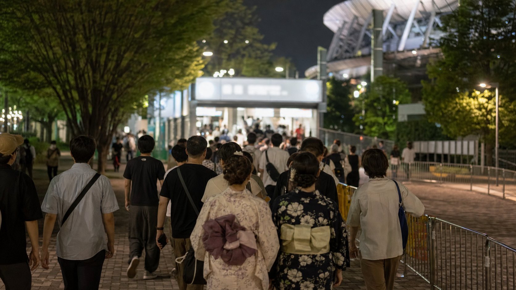 After-event crowd walking calmly toward a generic Tokyo metro station.
