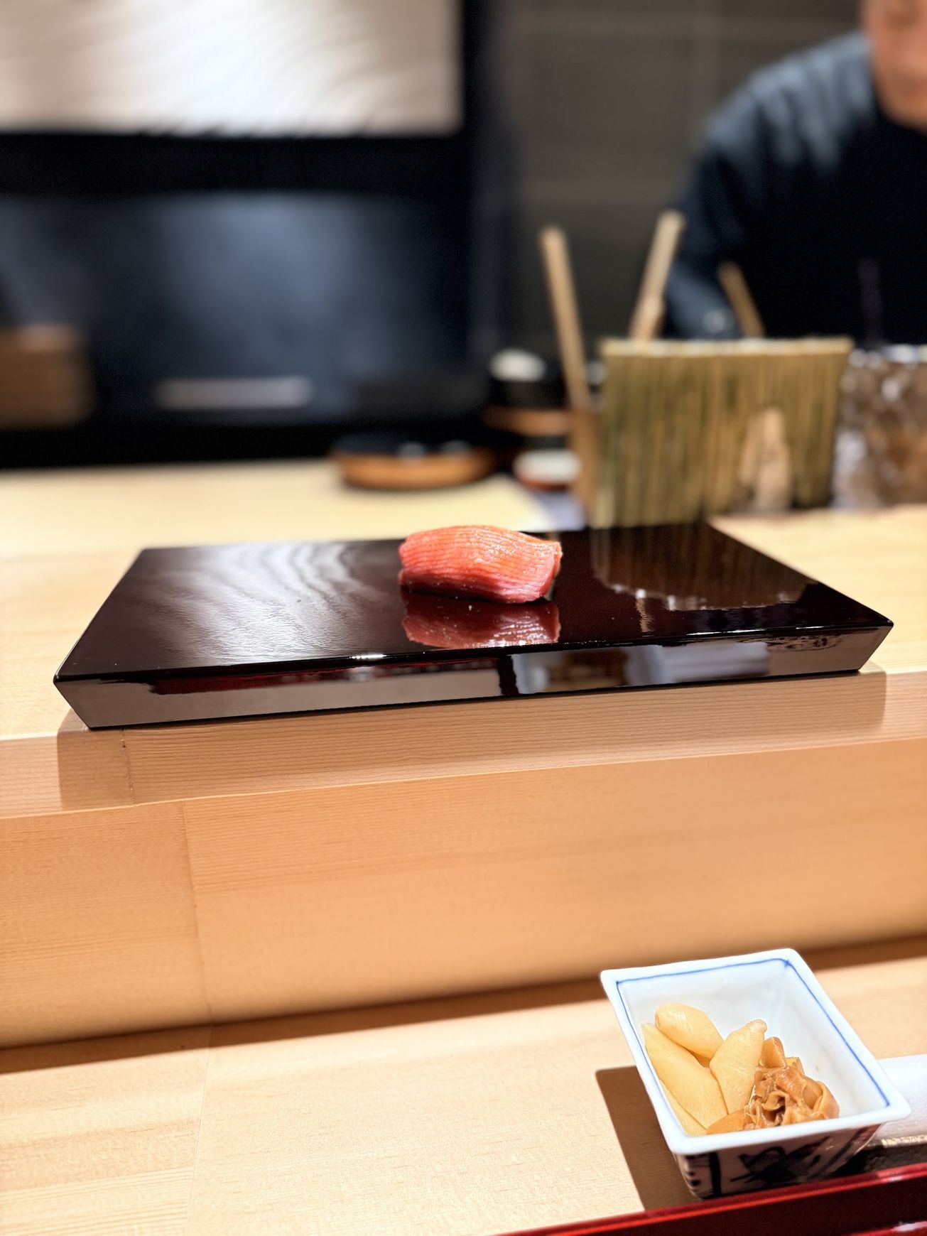 Otoro fatty tuna nigiri served on a black lacquer board at Sushi Kensuke