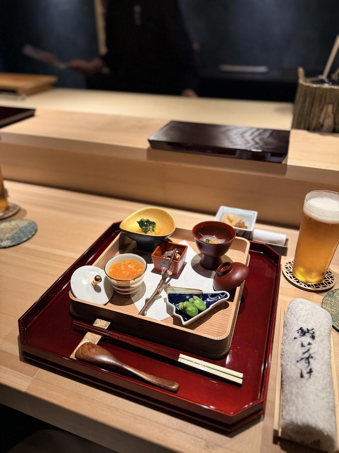 Seasonal hassun assortment with chawanmushi, boiled fava beans and sakura shrimp