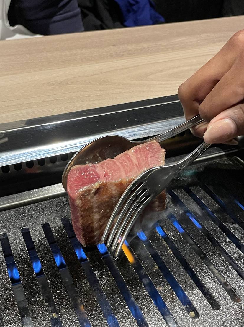 Staff grilling a thick wagyu steak at GYU CHIBA near Chiba Station