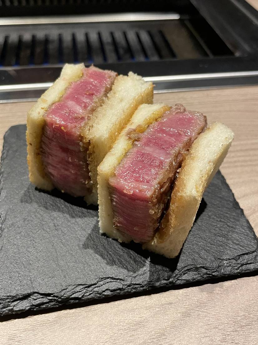 Chateaubriand wagyu katsu sandwich served on a black slate plate