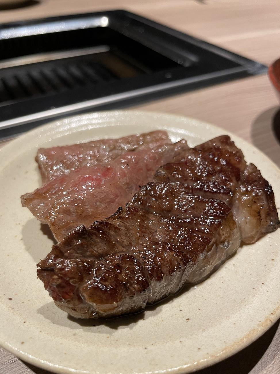 Grilled wagyu steak served on a small ceramic plate at GYU CHIBA