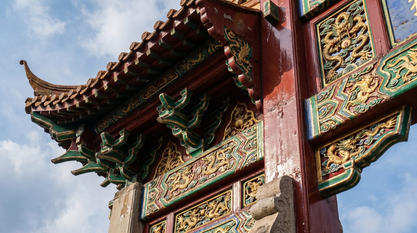 Close-up of dragon carvings on a Chinese paifang gate