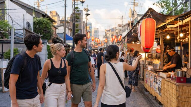 Travelers approach food stalls at a Japanese summer shopping-street festival