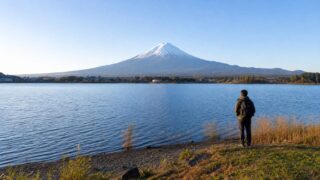 Traveler viewing Mt. Fuji across Lake Kawaguchiko in the morning