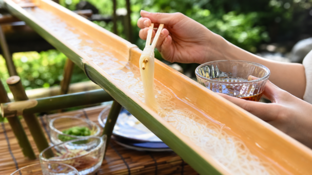 Nagashi somen noodles flowing down a bamboo-style lane near Tokyo