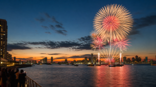 Tokyo Bay waterfront fireworks at twilight