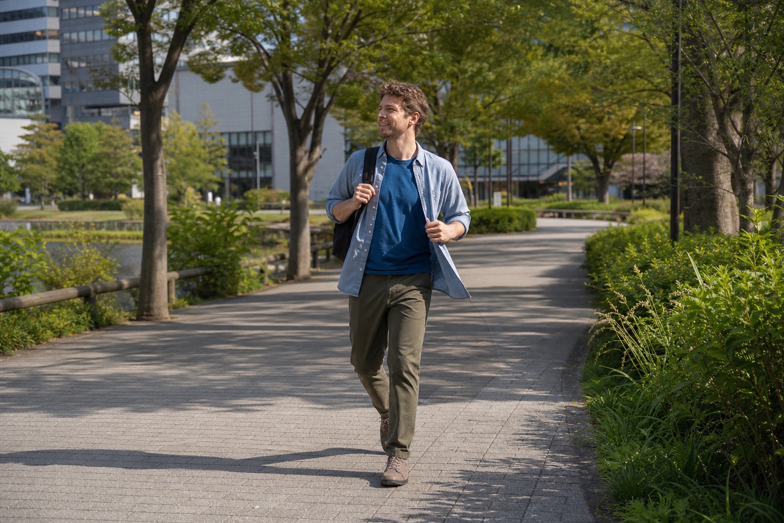 Traveler wearing a T-shirt and light overshirt in a Tokyo park in early October