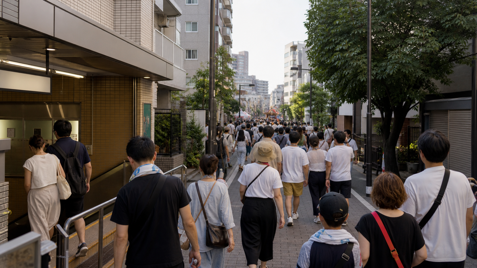 Visitors walking from a Tokyo station area toward a summer festival.