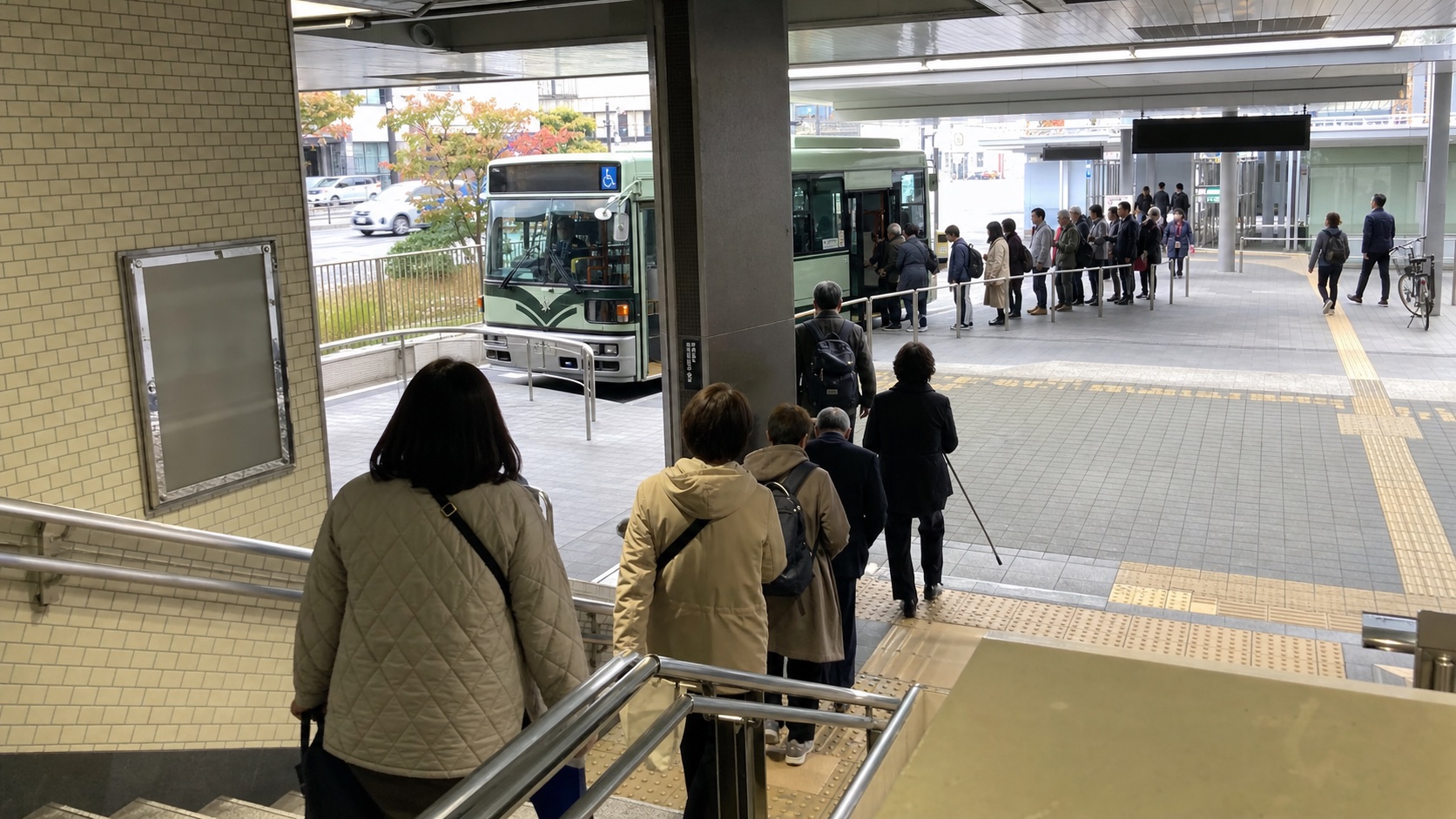 Travelers transferring from the subway to a bus for Kinkaku-ji