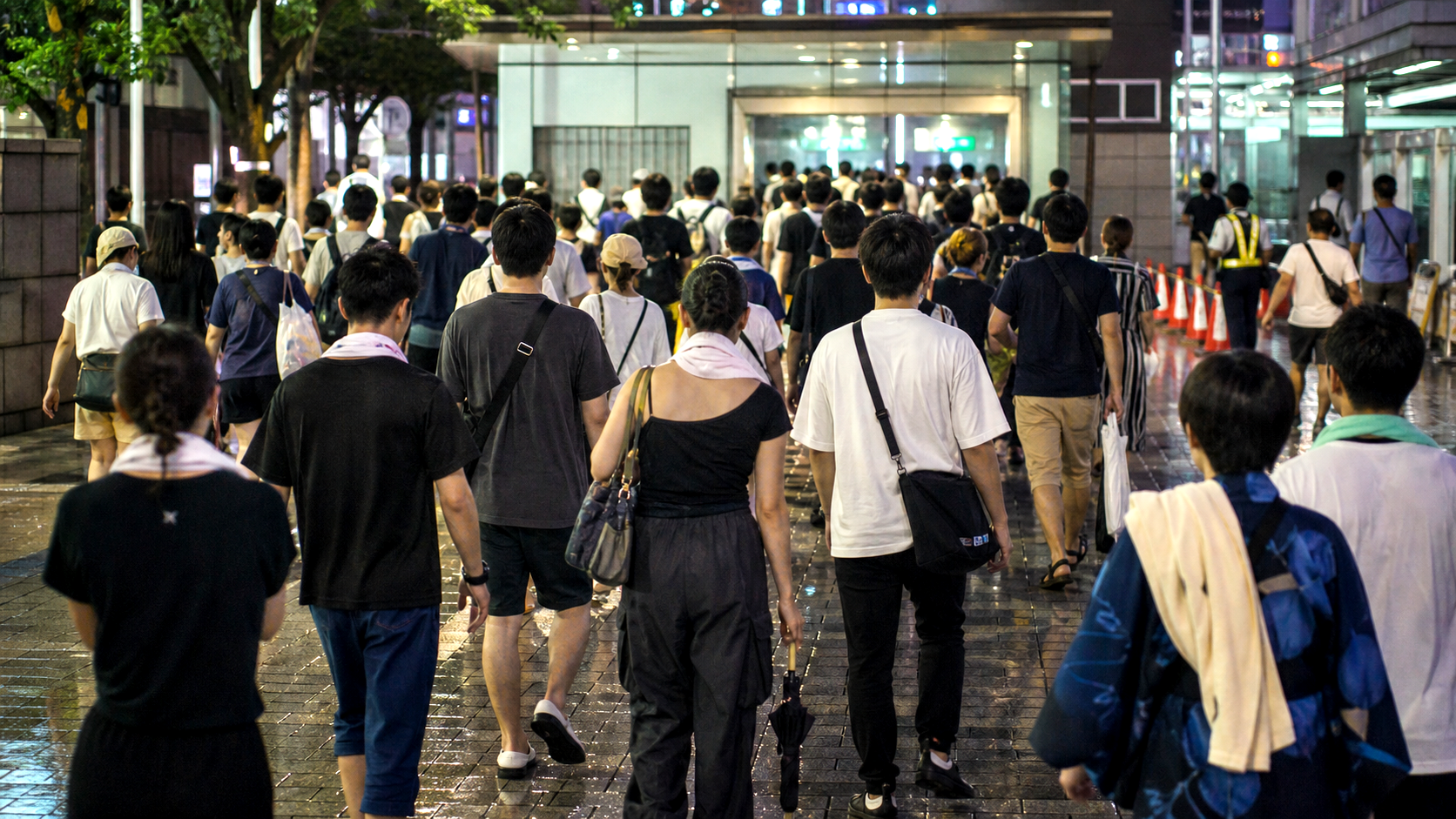 After-festival crowd walking toward a generic Tokyo station entrance.
