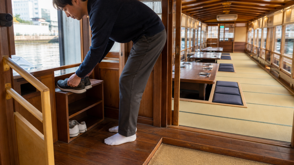 Shoes and horigotatsu seating inside a traditional yakatabune