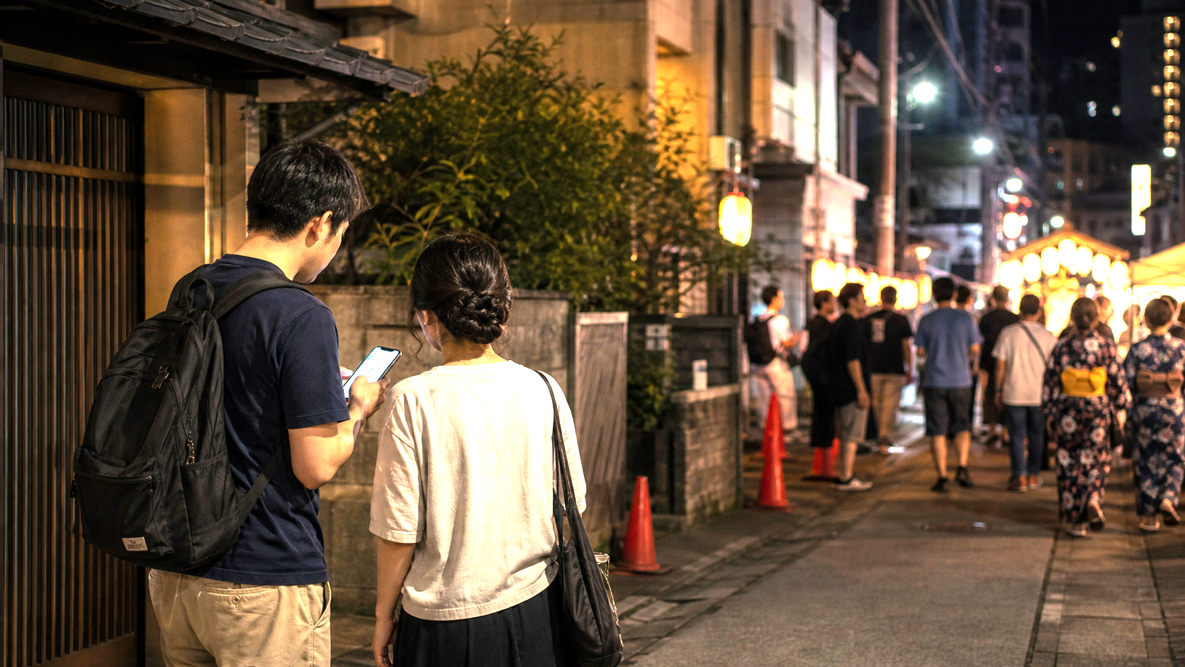 Photo-real AI image of travelers checking a route on a quieter side street near a festival.