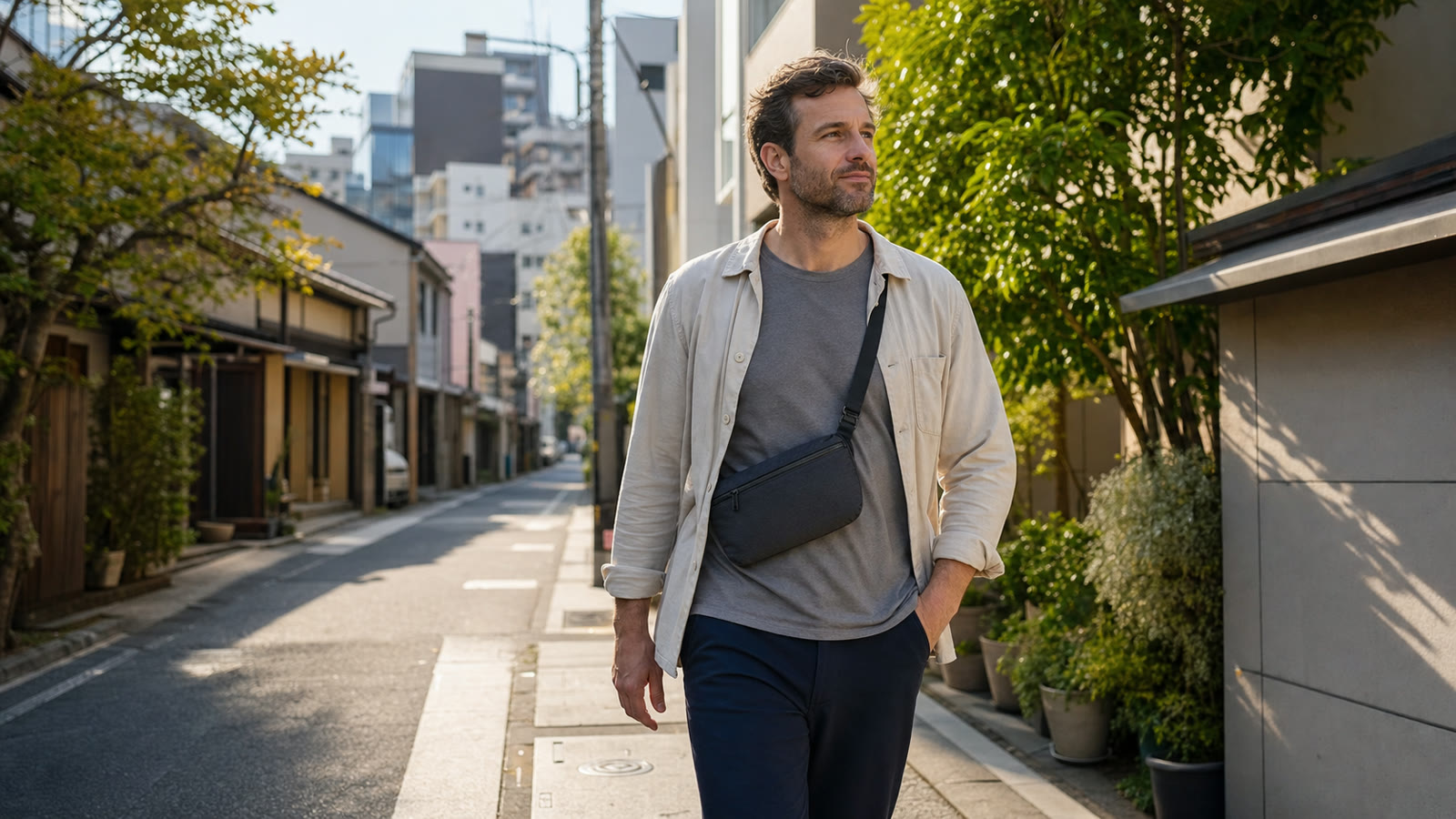 Prepared traveler walking through Tokyo with a zipped cross-body pouch