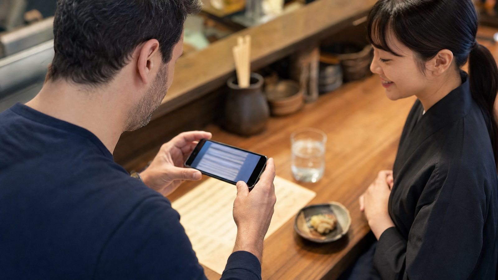 Traveler using a phone translation camera on a Japanese sake menu