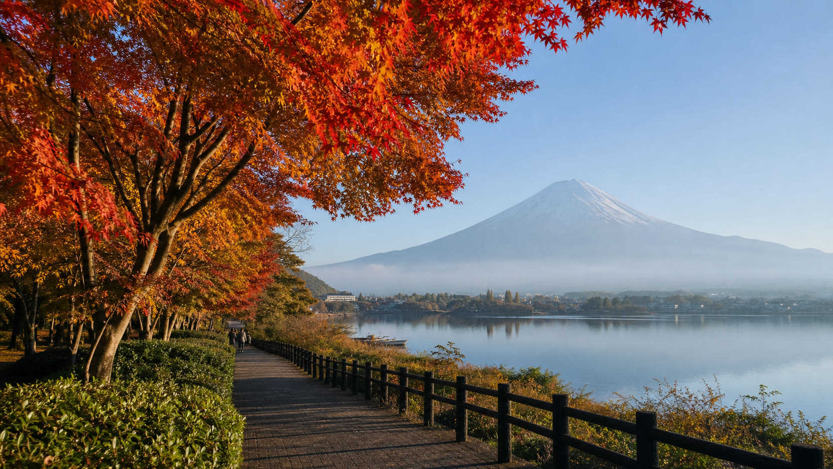 Autumn maple leaves beside Lake Kawaguchi with Mount Fuji in the distance