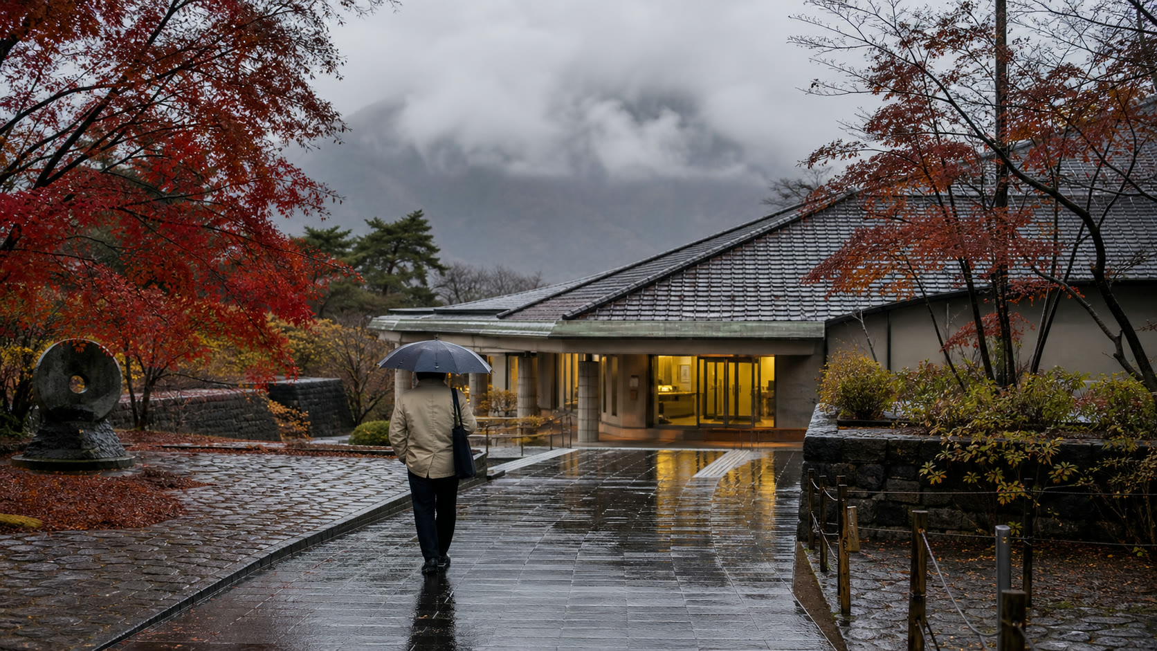 Traveler with an umbrella near an autumn museum area at Lake Kawaguchi