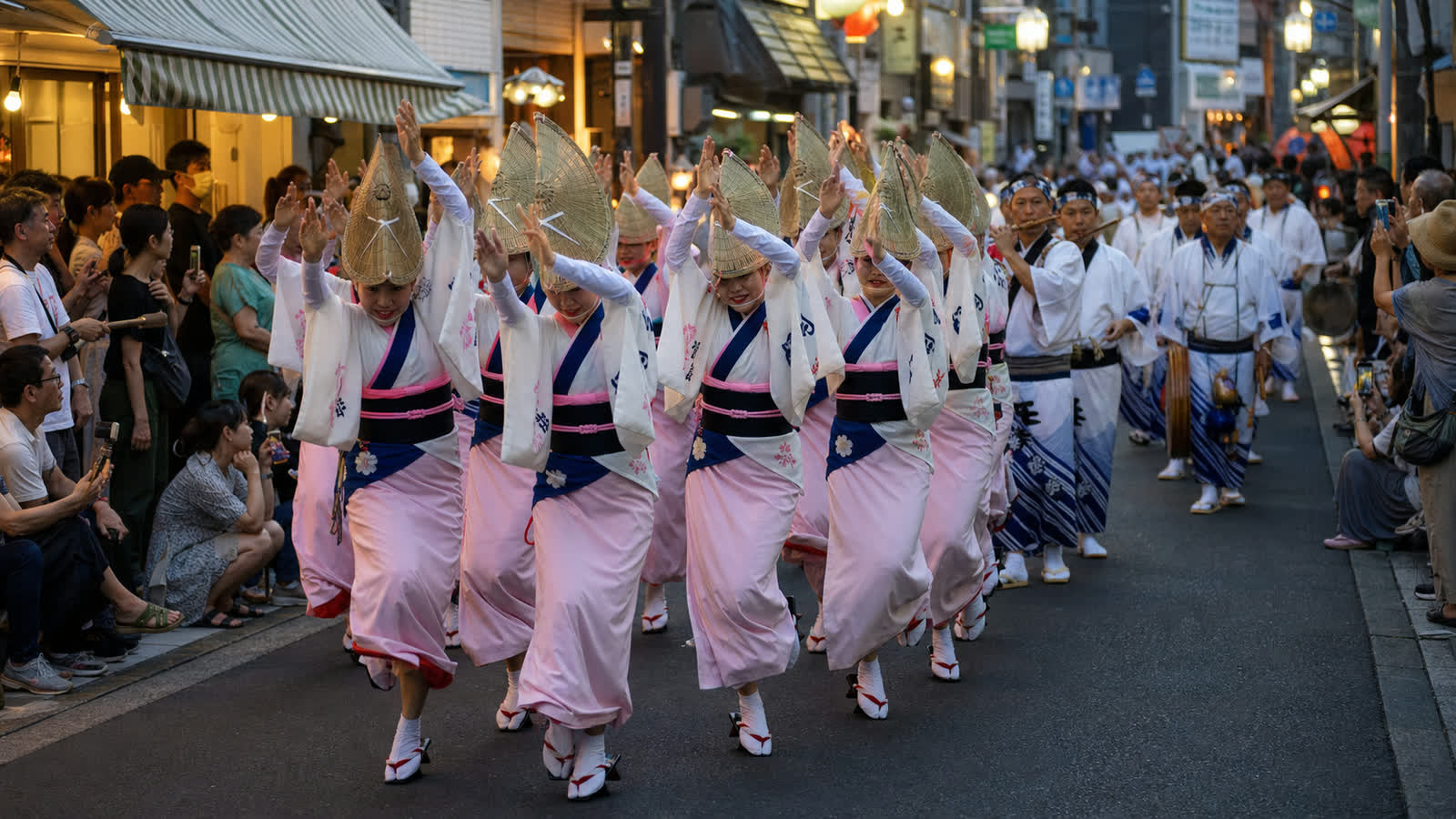 An Awa Odori ren entering a narrow Koenji shopping street