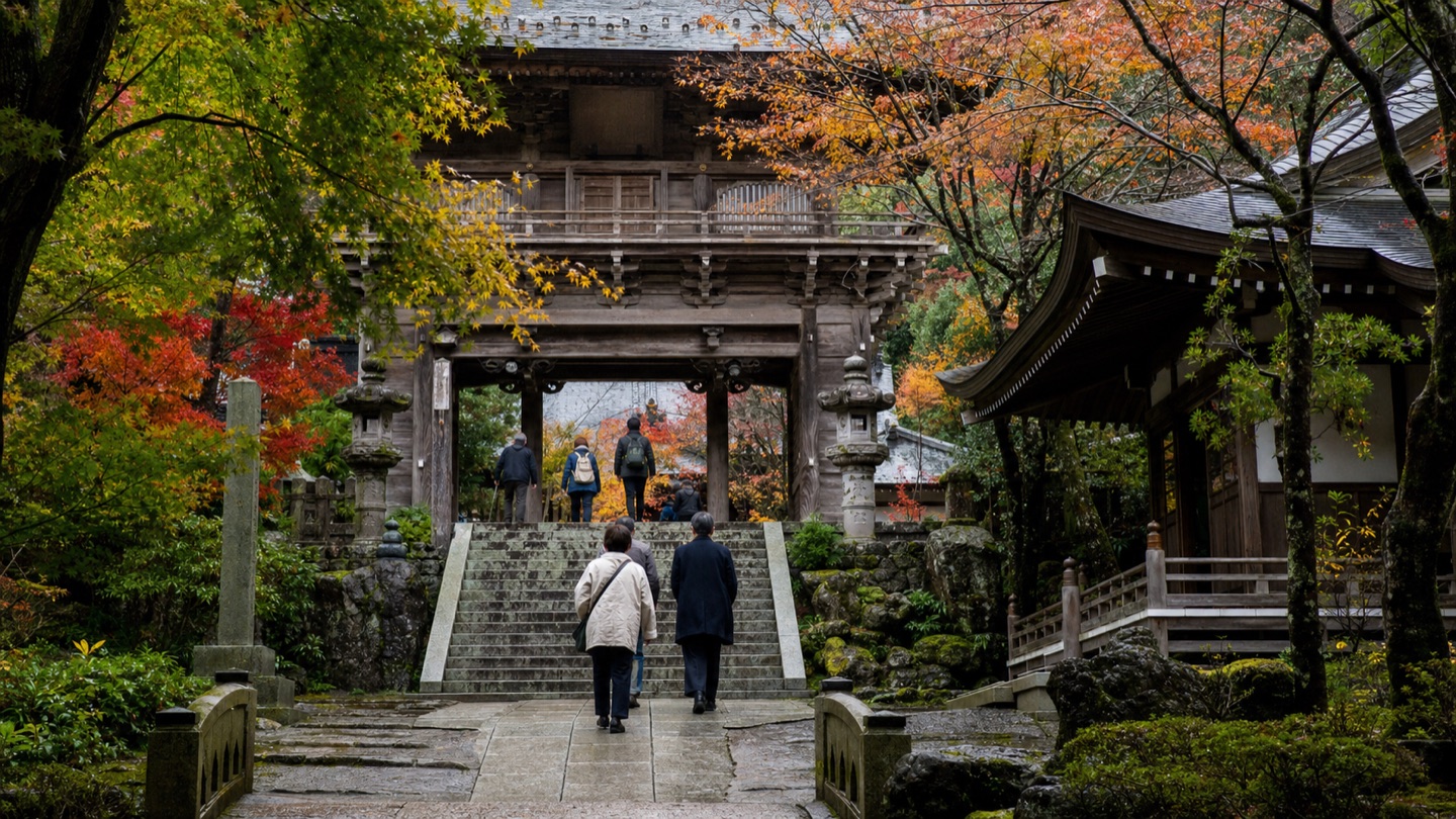 Visitors approaching Yakuoin Temple through autumn foliage