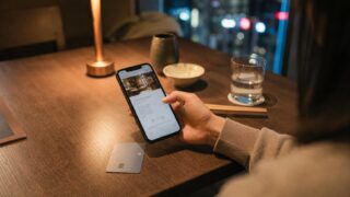Traveler checking a restaurant booking confirmation and card details in Japan.