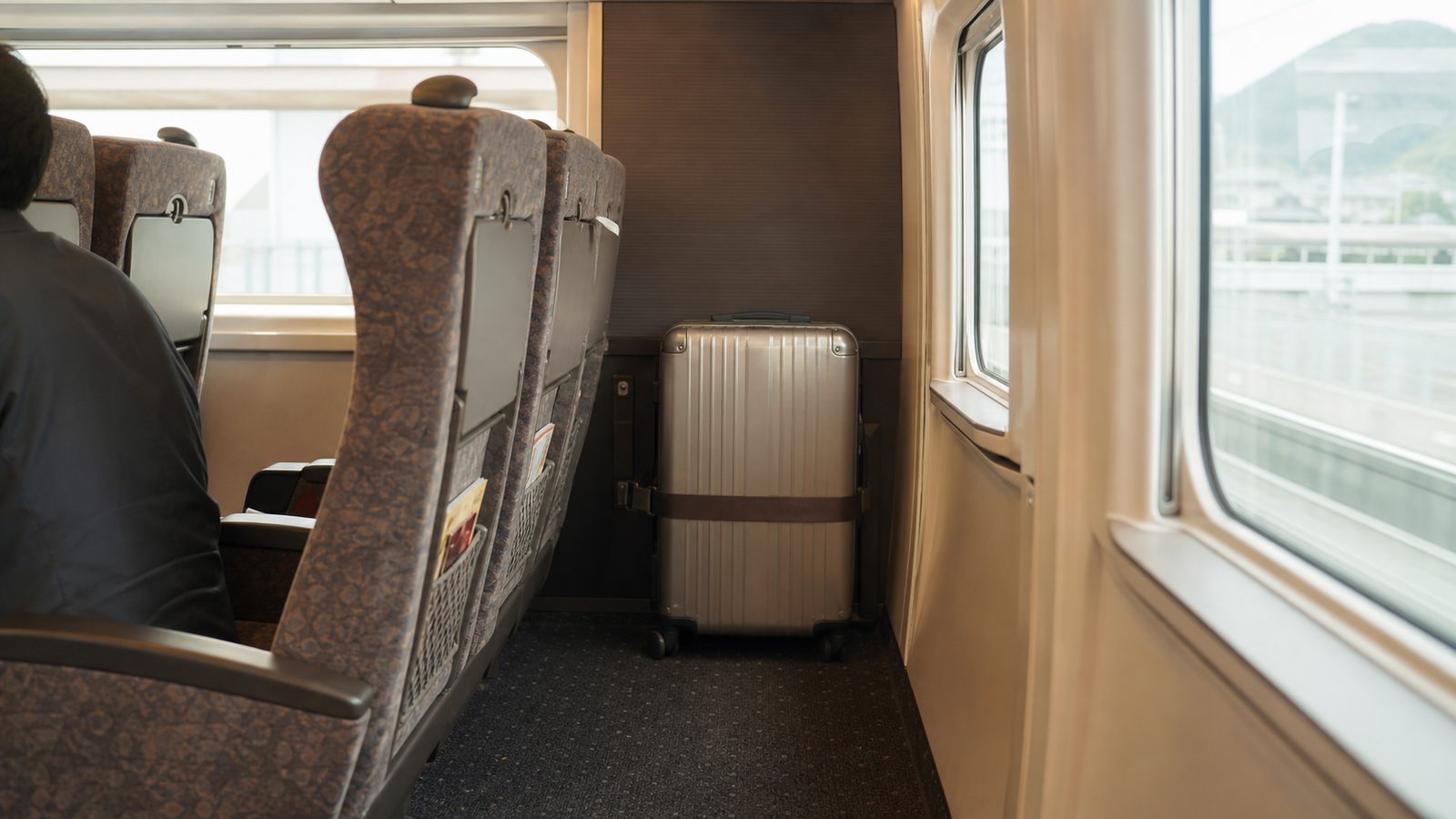 Large suitcase stored securely behind the last row of reserved Shinkansen seats