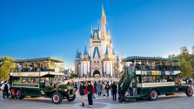 Cinderella Castle and two Omnibus vehicles at Tokyo Disneyland in daylight