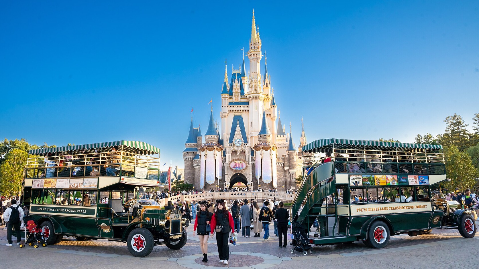 Cinderella Castle and two Omnibus vehicles at Tokyo Disneyland in daylight