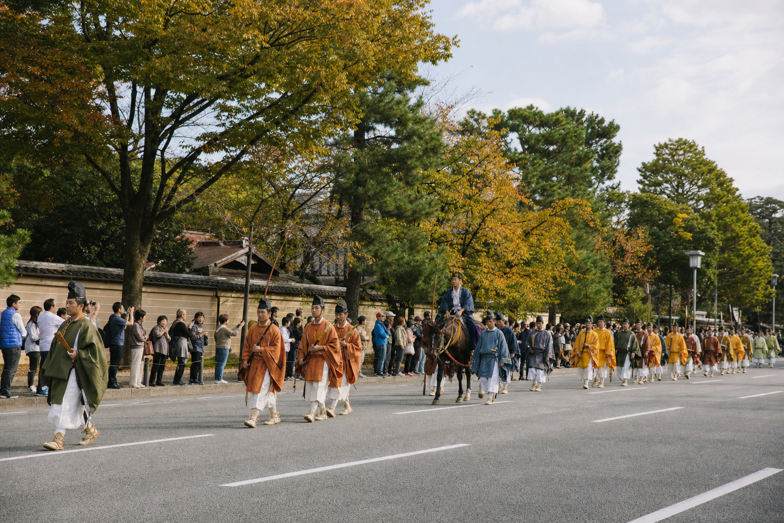 Autumn cultural procession moving along a broad Kyoto street while visitors watch from the curb