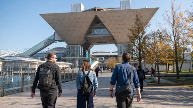 Overseas visitors approaching Tokyo Big Sight on a clear autumn day