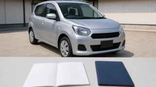 Compact rental car at a Japanese pickup area with a blank paper permit booklet and passport folder in the foreground
