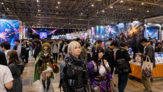 A large indoor pop-culture convention with original cosplayers, booths and a stage