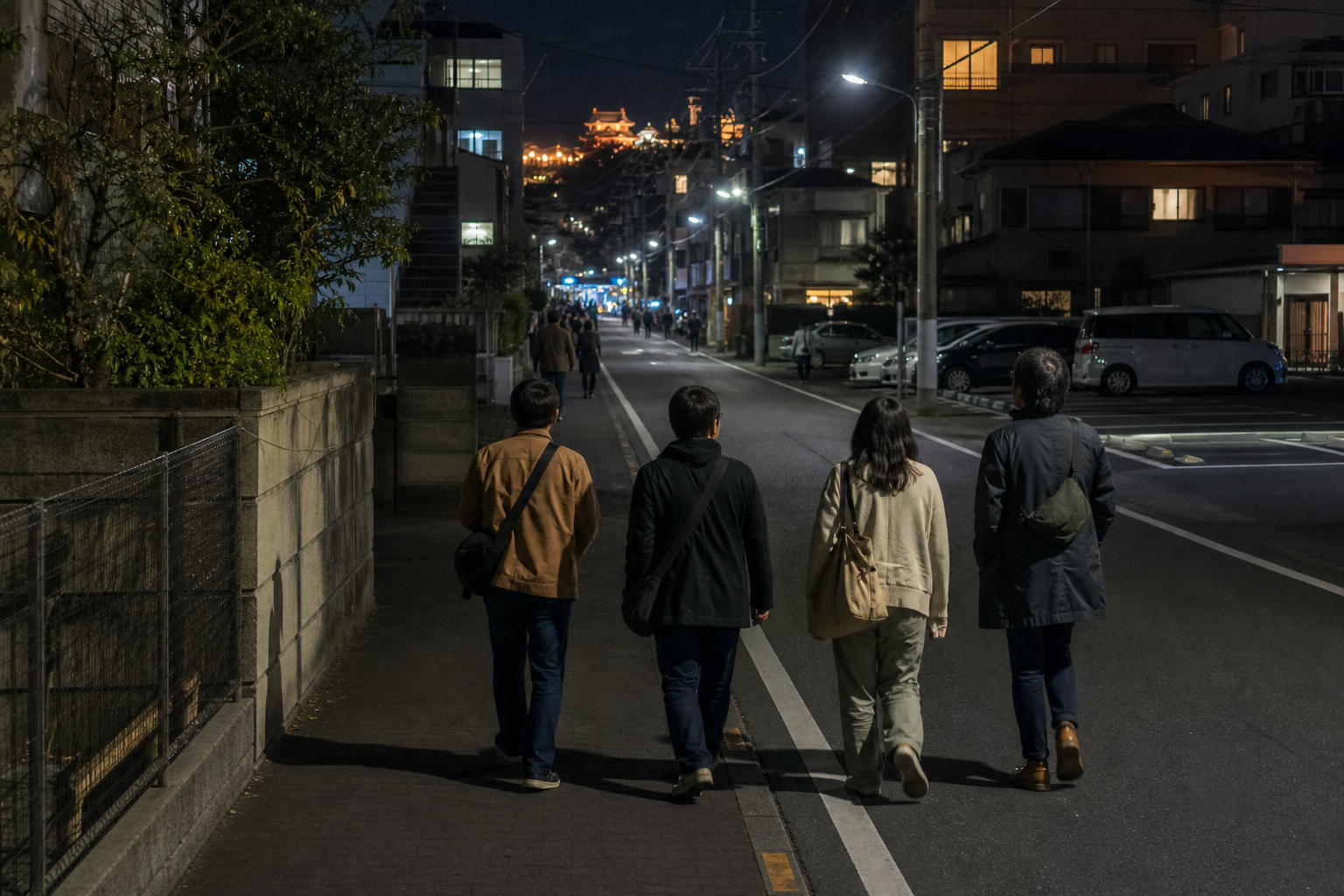 Visitors walking through ordinary city streets at night after leaving a festival