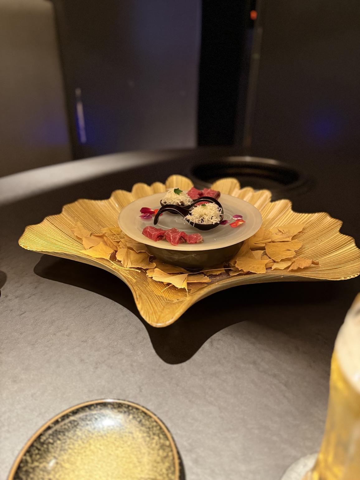 Wagyu tartare presented on a gold ginkgo-leaf plate at KIRAMEKI