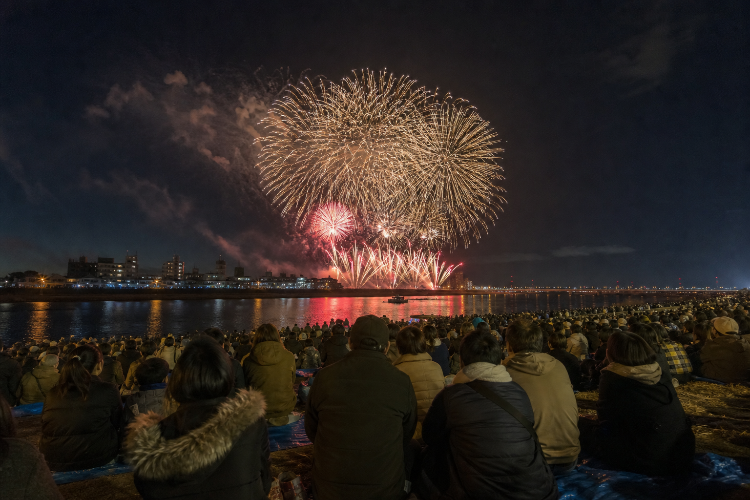 Autumn fireworks over the Sakuragawa riverbank with bundled spectators
