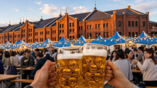 Beer steins raised before an Oktoberfest scene at Yokohama Red Brick Warehouse