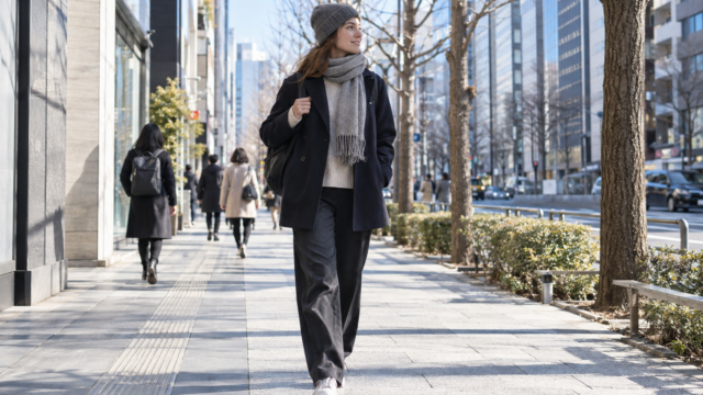 AI-generated editorial image of a traveler wearing removable winter layers in Tokyo.