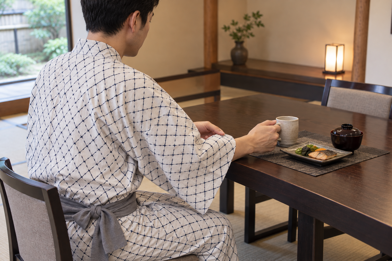 Male guest holding a loose sleeve clear with his opposite hand while holding a ceramic mug