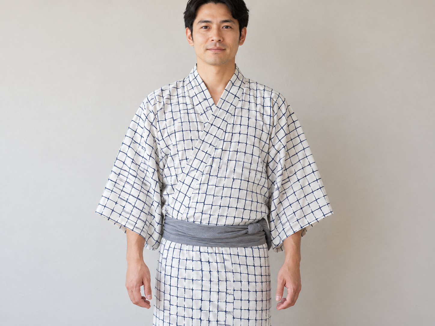 Front view of a man's white yukata with indigo checks, with the wearer’s left panel on top