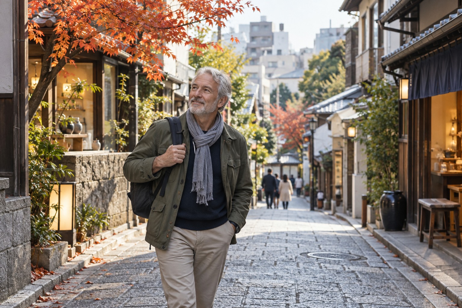 A gently sloping Tokyo shopping street with low shops and a solo older white male traveller